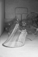 A fragment of the neck of a broken wine decanter. Packing box with broken glass. Vertical image. 