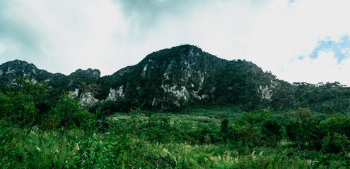 Panoramic beautiful green rock mountain with clear blue sky and cloud