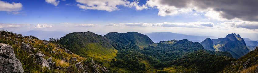 Fototapeta na wymiar Panoramic beautiful green rock mountain with clear blue sky and cloud