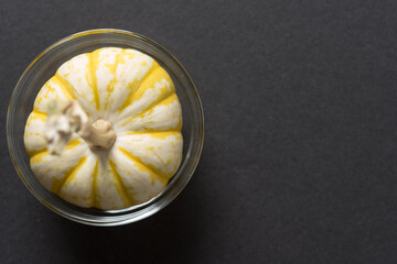 ornamental or decorative mini pumpkin in a glass bowl