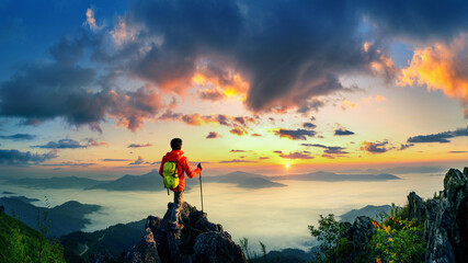 Panorama of Backpacker standing on Doi pha tang and sunrise in morning, Chiang rai, Thailand.