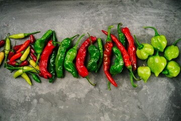 Different types of homegrown chillies or chilli peppers background, selective focus
