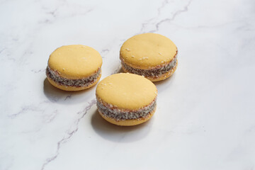 Traditional Argentinian alfajores with dulce de leche on marble table. Argentine gastronomy concept.