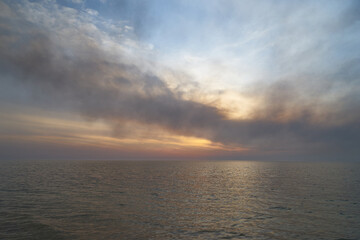 Sea sunset. Smoke wildfires sweeping across the sky.