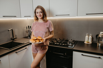 beautiful girl baked croissants in the kitchen
