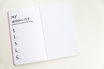 Notebook page marked 'my wishlist' in black ink on white paper. Goals and priorities of one's life....