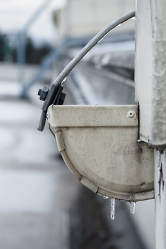 Two small icicles on the gutter drain with ground to the lightning conductor.