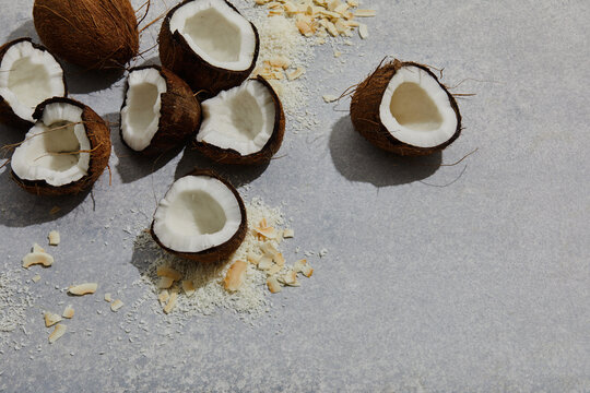 coconut shells cracked open on grey background