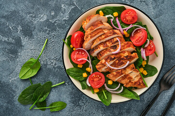Chicken fillet with salad spinach, cherry tomatoes, cornflower and onion. Healthy food. Keto diet, diet lunch concept. Top view on white background.