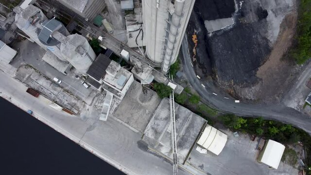 Vertical view of the old norcem factory. Tower with radar on top. Scandinavian crime movie look to it. Cinematic footage. 