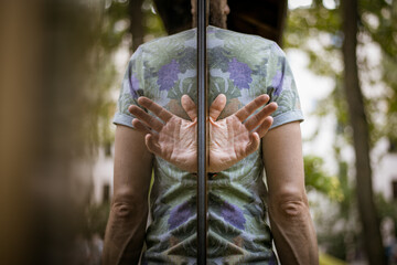 Abstract picture of human hands in reflection resembling wings. Hands growing out of back. 