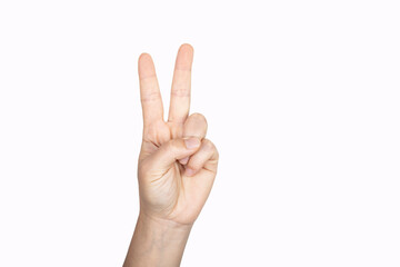 Closeup of female hand showing victory sign.