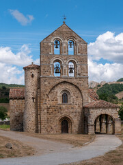 Fototapeta na wymiar The beautiful facade with bell tower of the stone church of a town in Spain