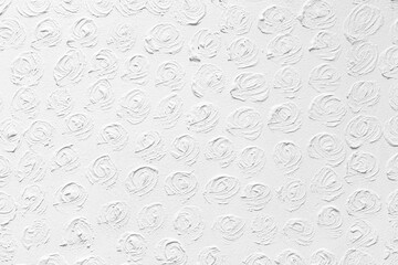 The cement wall is painted white with a circular pattern texture and background seamless