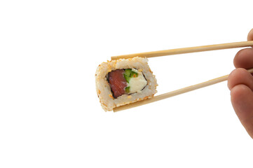 a woman's hand holds sushi with wooden sticks close-up,isolated on white