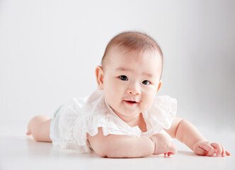 Closeup of cute Asian baby playing on the floor