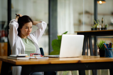 Portrait of smiling beautiful business asian woman with working in modern office desk using computer, Business people employee freelance online marketing e-commerce telemarketing concept.