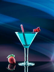 Blue cocktail of fruits on colorful lights background