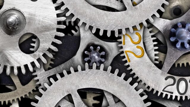 Rotating tooth wheel with New Year 2022 and group of wheels going from 2018 to 2021. High quality 4k video.