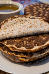 Lahmajun round, thin piece of dough topped with minced meat.