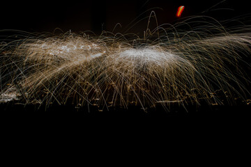 Sparks of electricity falling on a black background