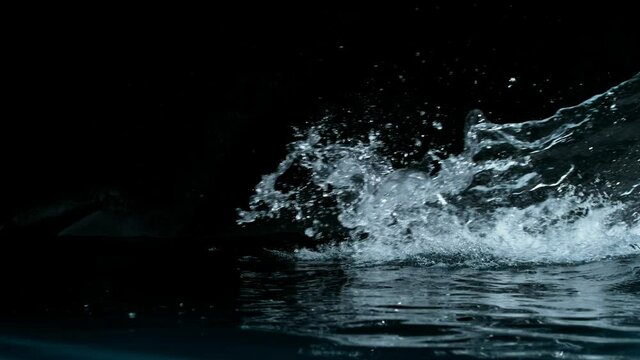 Super slow motion of big water splash on black background. Filmed on high speed cinema camera, 1000 fps.