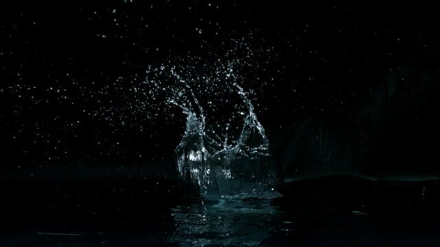 Super slow motion of big water splash on black background. Filmed on high speed cinema camera, 1000 fps.