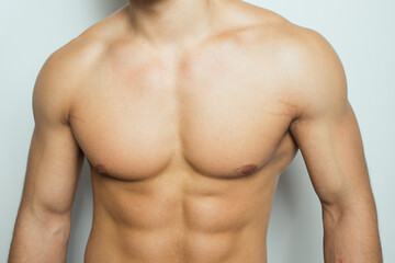 the torso of a young athletic guy. concept: the male body after exercise and diet. men's health:...