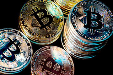 Horizontal view of cryptocurrency tokens, including Bitcoin, dogecoin, and ethererum seen from above on a black background. High quality photo