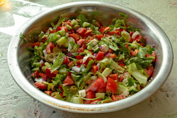 Salad with olives, lettuce, tomatoes, paprika, onions and Mozzarella cheese. Greek salad in a large bowl