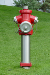 Fototapeta premium German fire hydrant placed in open green field to secure the neighboured people, Wolfsburg, Germany