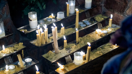 Candles in a church at the altar with candles praying. Christmas event.