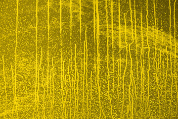 Abstract yellow background. Empty flat surface with white stains from water or liquid. Back for design