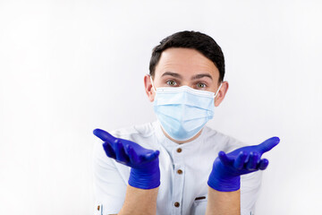 The guy in the medical mask and gloves. Virus protection. Precautionary Methods. Doctor on a white background. Blue medical gloves.
