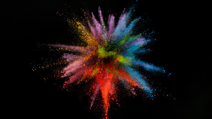 Freeze motion shot of color powder explosion isolated on black background, close-up.