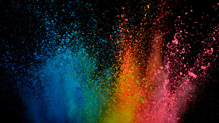 Freeze motion shot of color powder explosion isolated on black background, close-up.