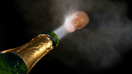 Freeze motion of Champagne explosion with flying cork closure, opening champagne bottle closeup...