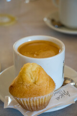 Muffin and coffee on wooden table.
