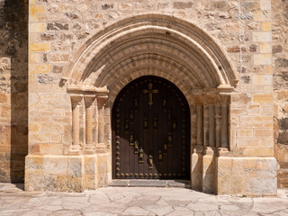 A closeup of the entrance door to a monastery in the mountains of Europe in Spain