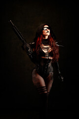 Attractive sexy young woman, armed with an assault rifle, wearing futuristic clothes