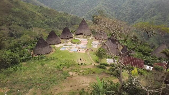 Aerial view of Traditional houses in Wae Rebo village in the jungle, Flores, Indonesia. Famous Manggarai's traditional villages, consist of 7 custom houses. 4K drone footage flying over the village.