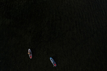 Two people paddleboarding on the ocean in Honolulu, Hawai'i