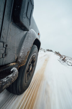 4x4 driving across snowy and icy road