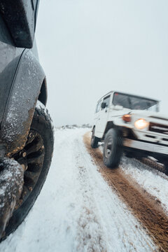 4x4 cars driving across snowy and icy road in Tenerife