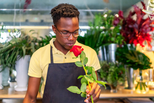 young african entrepreneur smelling the flowers of his business
