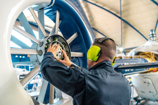 professional mechanic repairing helicopter engine