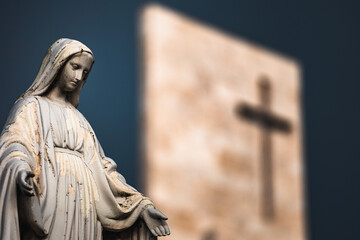Fototapeta premium The statue of Virgin Mary in front of a modern church's tower