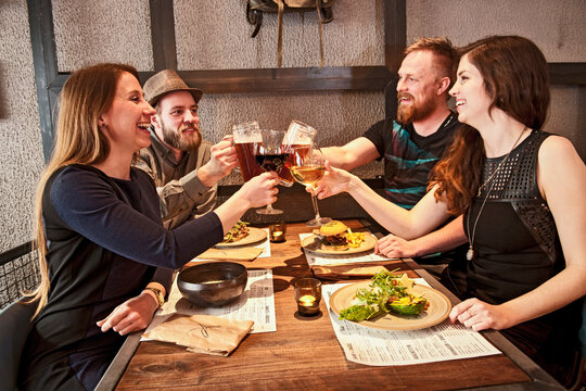 Friends having a good time at hipster bar in Reykjavik