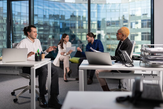 Multiracial colleagues having business meeting in office