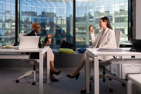 Diverse businesswomen talking during break